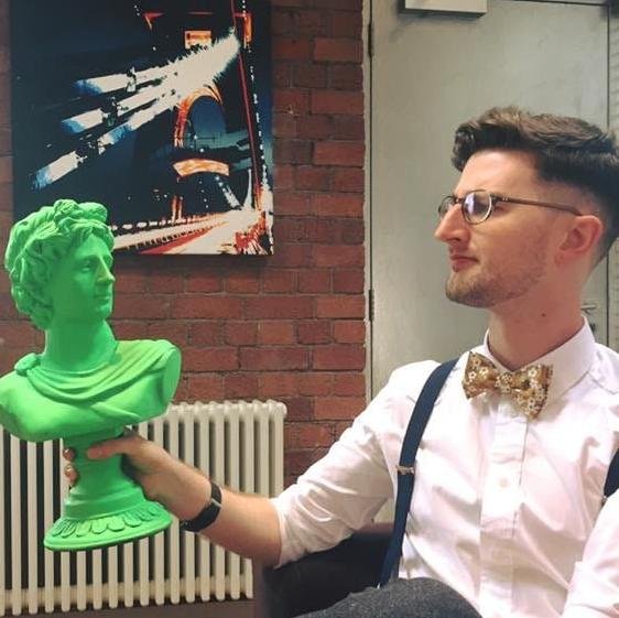 Rob Hancock-Jones, holding a green plastic version of an ancient bust