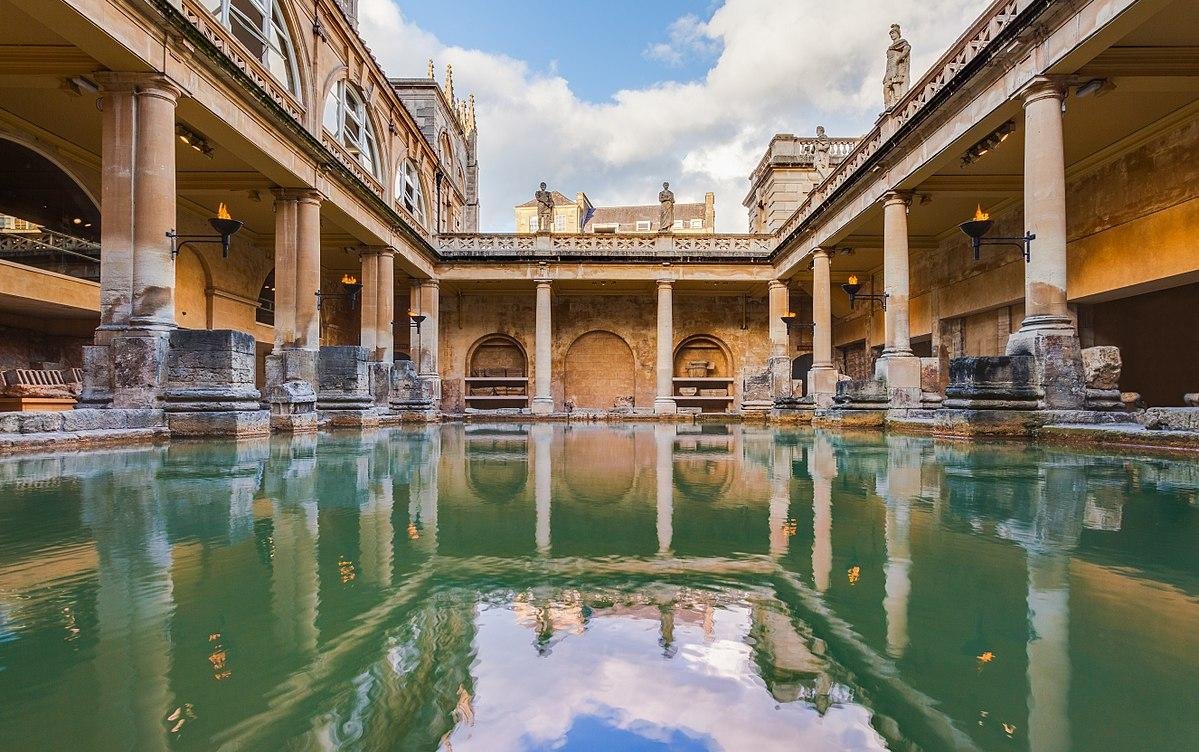 The main bath at Aquae Sulis in the modern day site in Bath, UK. Aspects of the medieval and modern city are reflected in the water.